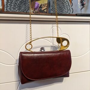 Elegant Burgundy Clutch with Gold Accents